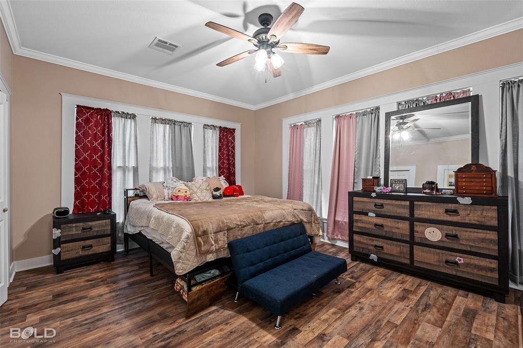 508 Chandler Street Minden, LA 71055 - Photo 23 of 35 a bed room with a bed and a chandelier
