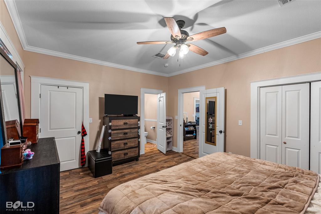508 Chandler Street Minden, LA 71055 - Photo 24 of 35 a bedroom with a bed and a flat tv screen on dresser