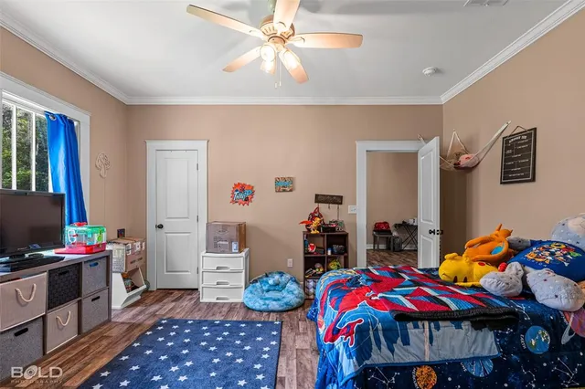 a bedroom with furniture and a flat screen tv
