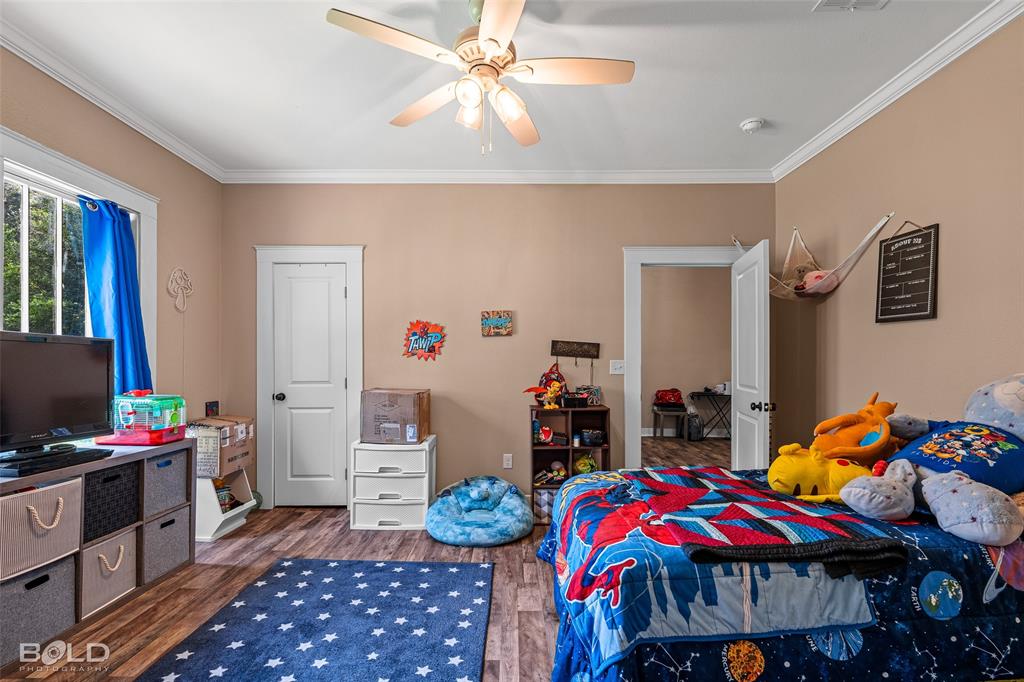 508 Chandler Street Minden, LA 71055 - Photo 27 of 35 a bedroom with furniture and a chandelier