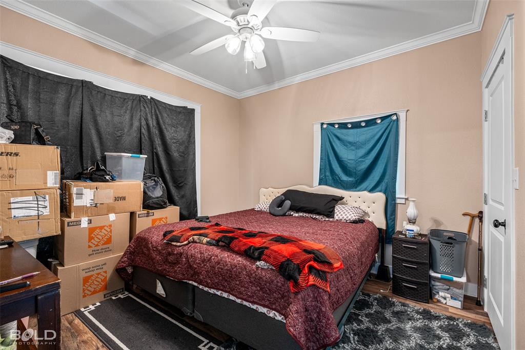 508 Chandler Street Minden, LA 71055 - Photo 30 of 35 a bedroom with a bed and a chandelier