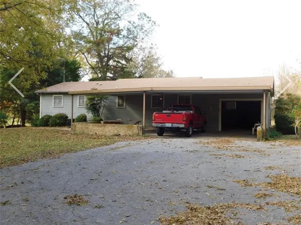 a view of a house with a yard and pathway