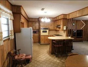 a kitchen with a refrigerator and a table