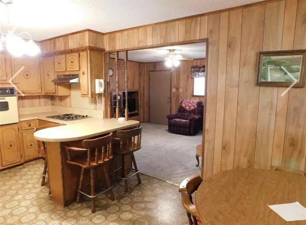 a dining room with furniture and a chandelier