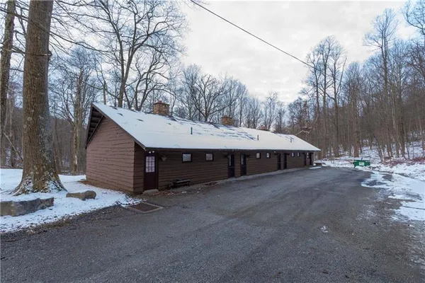 a view of a house with a yard and covered with snow