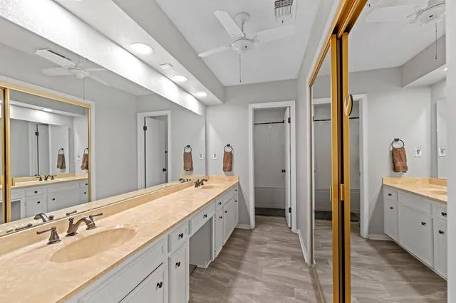 a spacious bathroom with a double vanity sink and a mirror