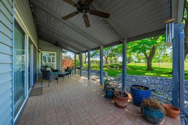 a view of a porch with chairs and backyard