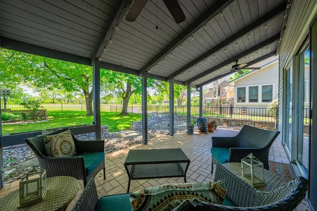 a building outdoor space with patio furniture and a garden