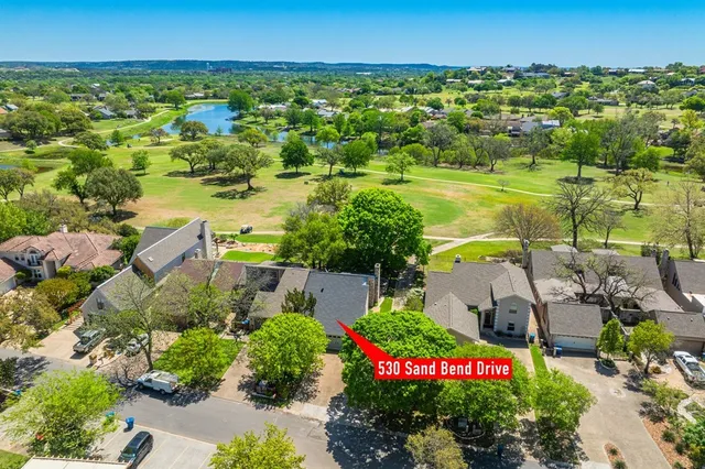 an aerial view of residential houses with outdoor space and street view