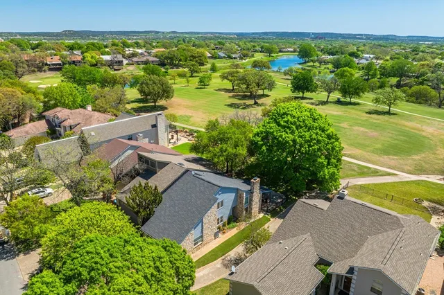 an aerial view of a house with garden space and outdoor seating