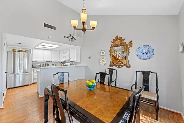 a view of a dining room with furniture and a chandelier