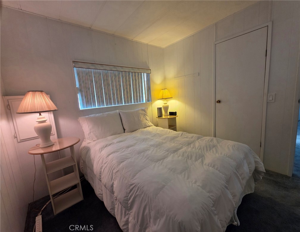 20806 Gridley Road, Unit 52 Lakewood, CA 90715 - Photo 12 of 51 a bedroom with a bed and a lamp
