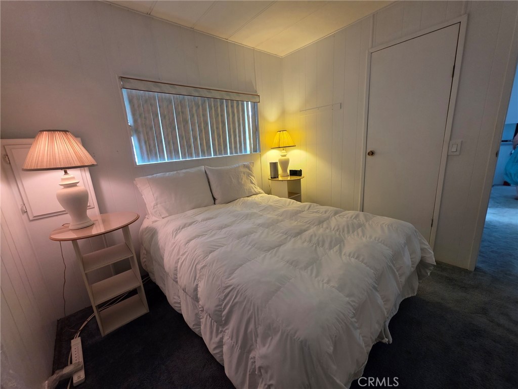 20806 Gridley Road, Unit 52 Lakewood, CA 90715 - Photo 13 of 51 a bedroom with a bed and a lamp