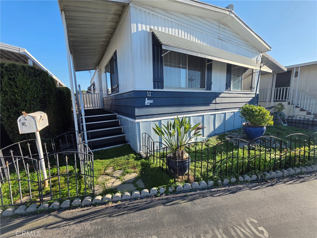 20806 Gridley Road, Unit 52 Lakewood, CA 90715 - Photo 21 of 51 a front view of a house with garden