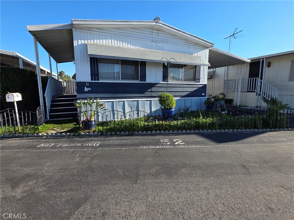 20806 Gridley Road, Unit 52 Lakewood, CA 90715 - Photo 23 of 51 a front view of a building with a yard