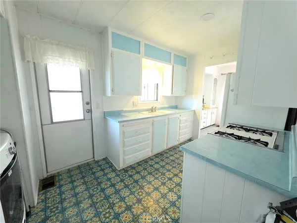 a kitchen with a sink stove and cabinets