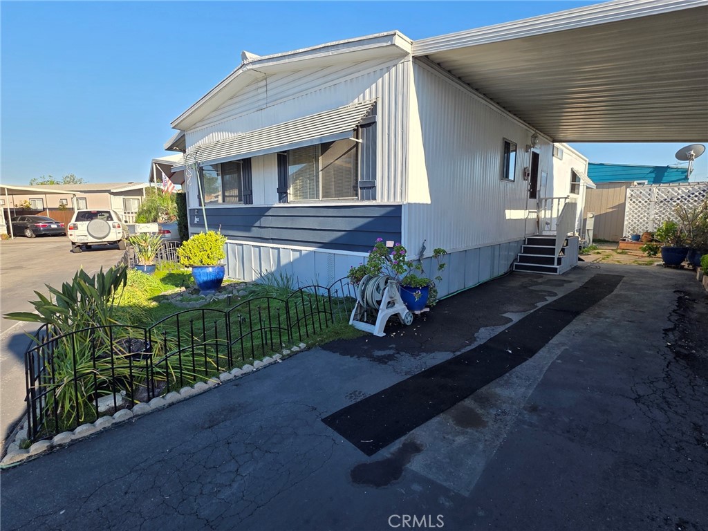 20806 Gridley Road, Unit 52 Lakewood, CA 90715 - Photo 3 of 51 a front view of a house with garden