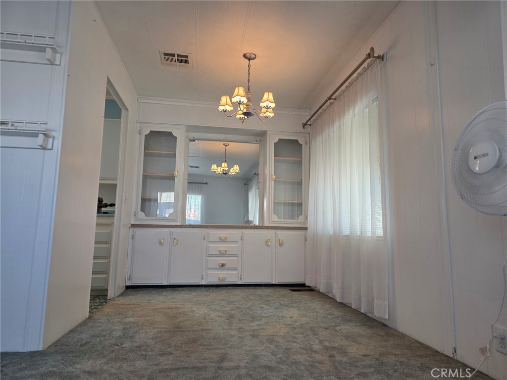 20806 Gridley Road, Unit 52 Lakewood, CA 90715 - Photo 44 of 51 an empty room with wooden floor cabinet and windows