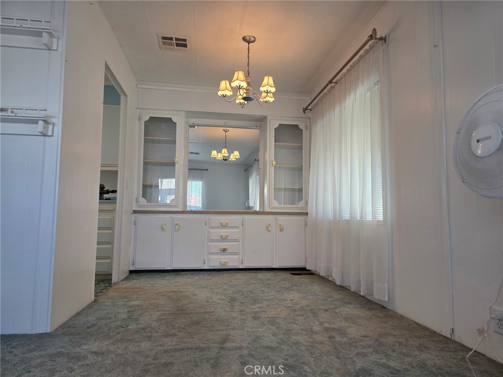 20806 Gridley Road, Unit 52 Lakewood, CA 90715 - Photo 45 of 51 a view of an empty room with window and chandelier
