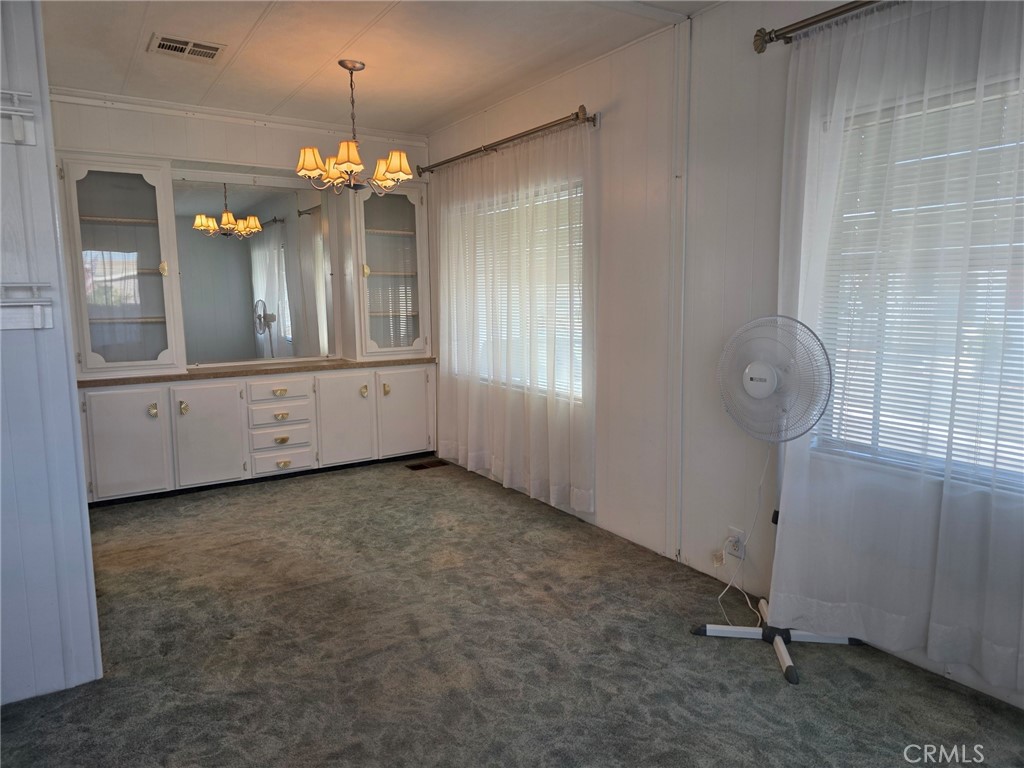 20806 Gridley Road, Unit 52 Lakewood, CA 90715 - Photo 46 of 51 a view of a hallway with chandelier