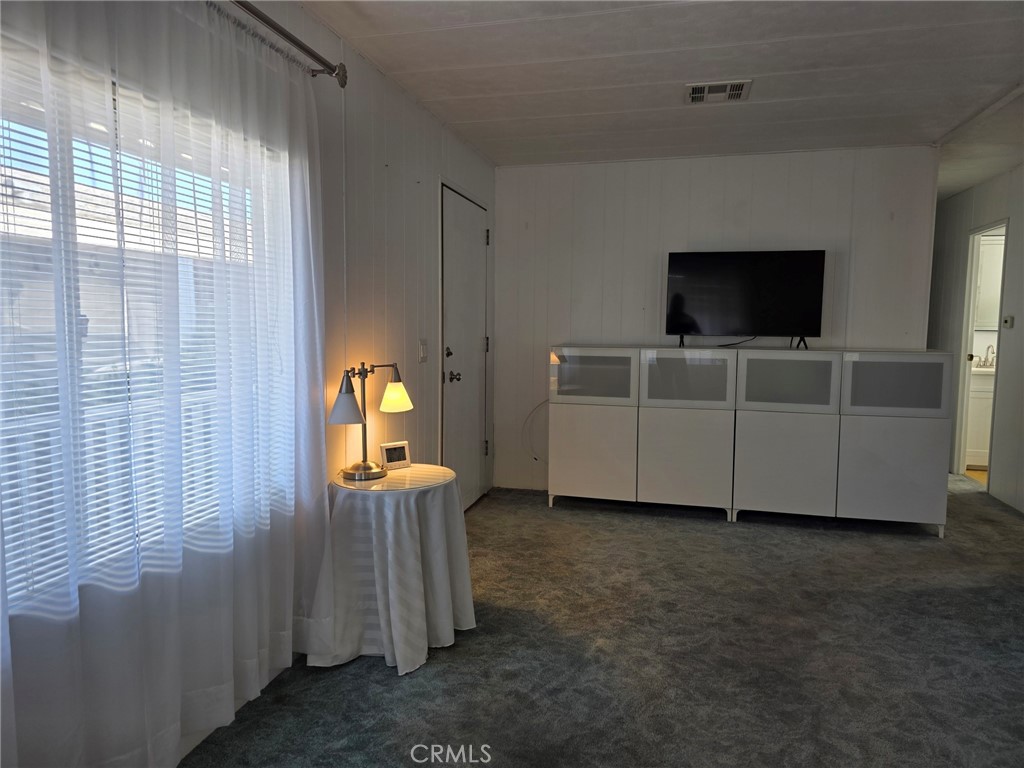 20806 Gridley Road, Unit 52 Lakewood, CA 90715 - Photo 49 of 51 a living room with furniture and flat screen tv