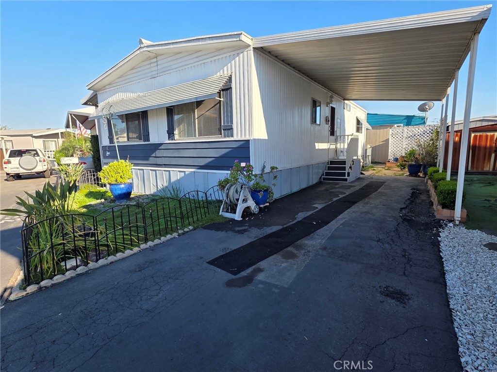20806 Gridley Road, Unit 52 Lakewood, CA 90715 - Photo 6 of 51 a front view of house with yard outdoor seating and barbeque oven