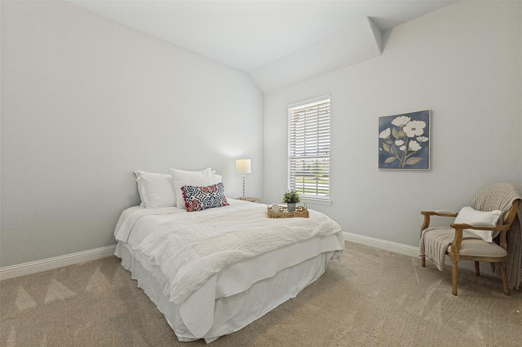 506 Life Spring Drive Rockwall, TX 75087 - Photo 28 of 36 a bedroom with a bed and a chair