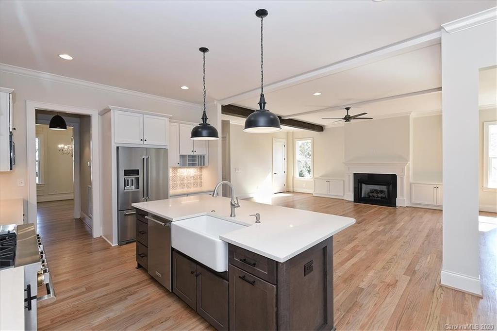 608 Marsh Road Charlotte, NC 28209 - Photo 12 of 31 a kitchen with kitchen island a sink stainless steel appliances and wooden floor