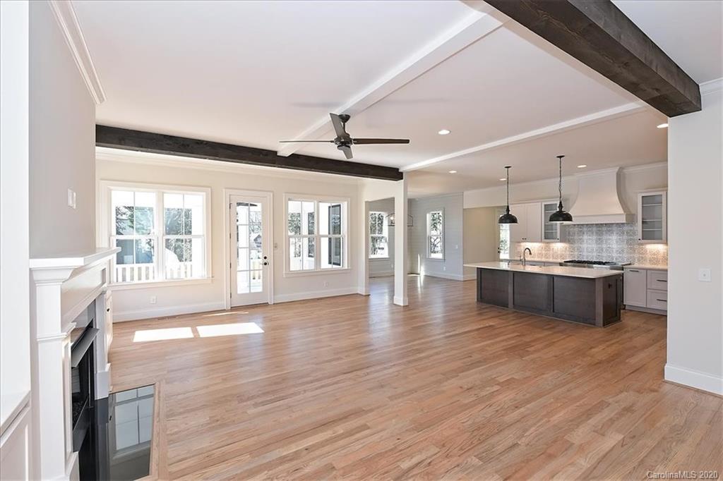 608 Marsh Road Charlotte, NC 28209 - Photo 13 of 31 a view of kitchen with granite countertop a stove top oven a sink and a dining table with wooden floor