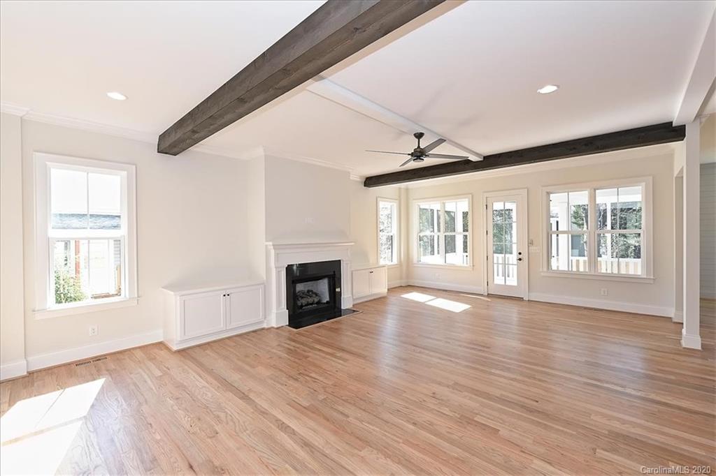 608 Marsh Road Charlotte, NC 28209 - Photo 15 of 31 a view of empty room with wooden floor and fireplace