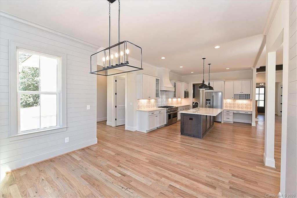 608 Marsh Road Charlotte, NC 28209 - Photo 16 of 31 a view of a kitchen and dining room with wooden floor windows