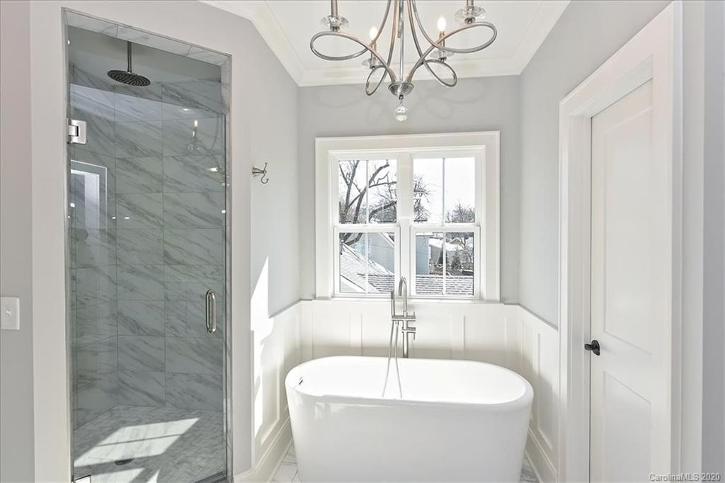 608 Marsh Road Charlotte, NC 28209 - Photo 20 of 31 a bathroom with a bathtub a shower and a sink