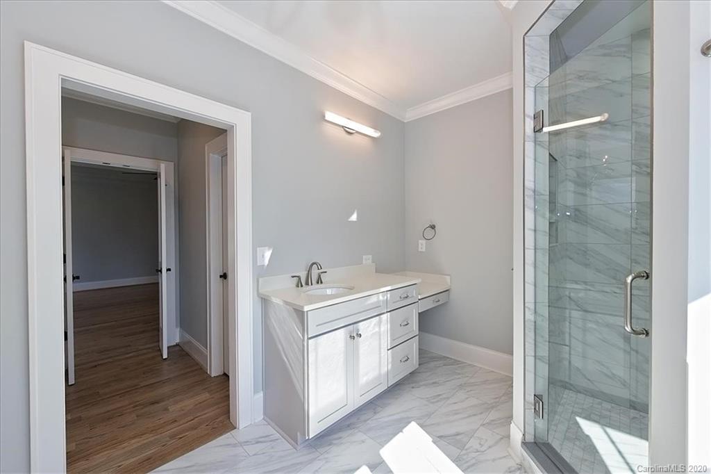 608 Marsh Road Charlotte, NC 28209 - Photo 21 of 31 a spacious bathroom with a shower sink and mirror