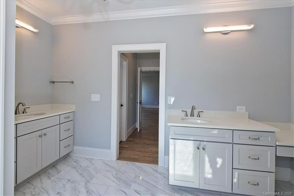 608 Marsh Road Charlotte, NC 28209 - Photo 22 of 31 a bathroom with a sink and a mirror