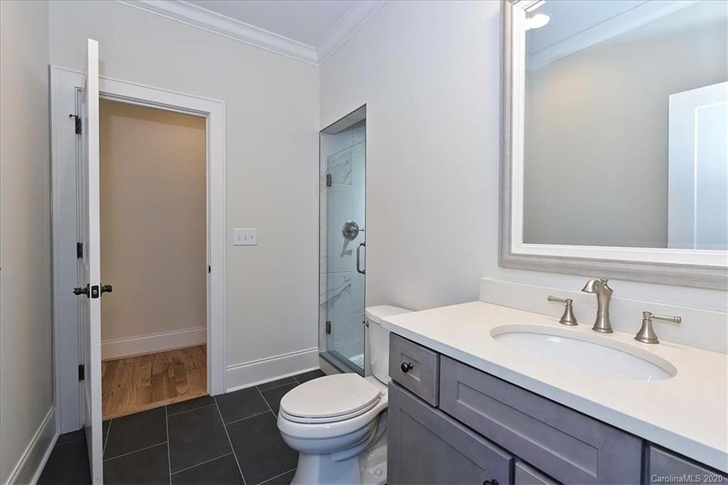 608 Marsh Road Charlotte, NC 28209 - Photo 24 of 31 a bathroom with a sink toilet a mirror and shower
