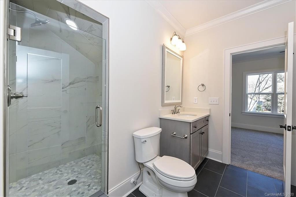 608 Marsh Road Charlotte, NC 28209 - Photo 25 of 31 a bathroom with a sink a toilet and shower