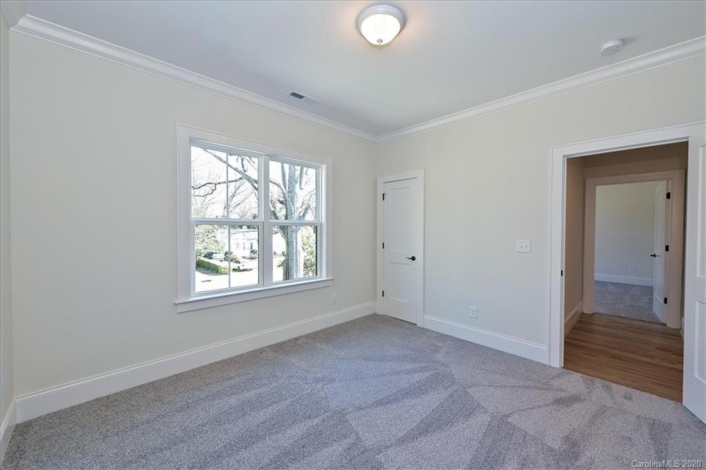 608 Marsh Road Charlotte, NC 28209 - Photo 26 of 31 a view of an empty room with wooden floor and a window