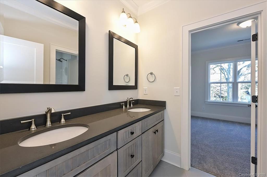 608 Marsh Road Charlotte, NC 28209 - Photo 27 of 31 a bathroom with double vanity sinks and a mirror
