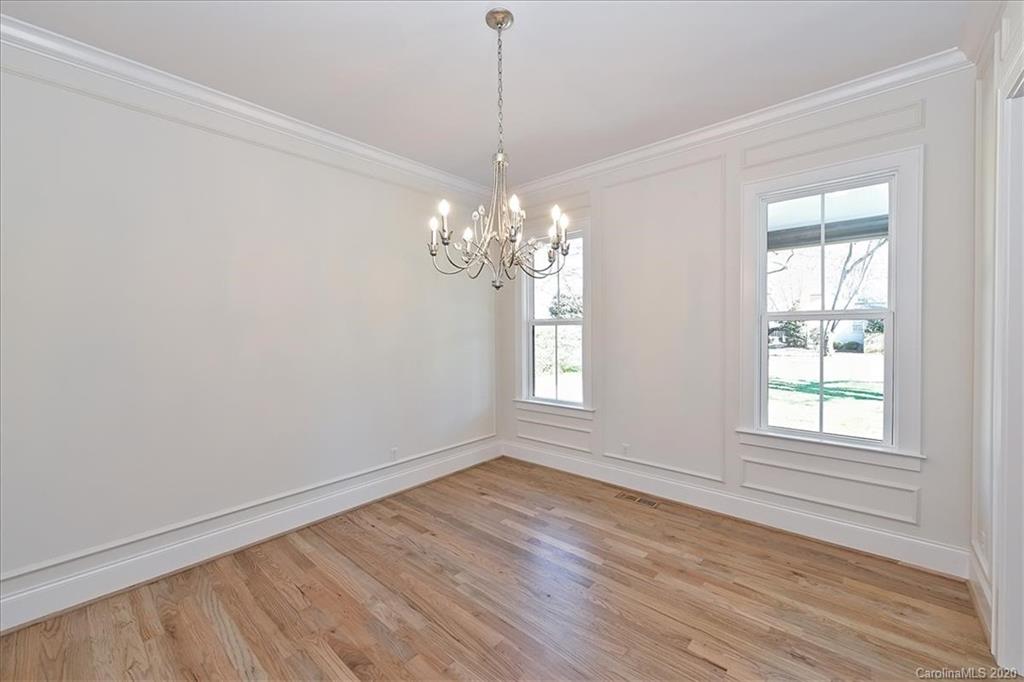 608 Marsh Road Charlotte, NC 28209 - Photo 6 of 31 a view of empty room with wooden floor and fan