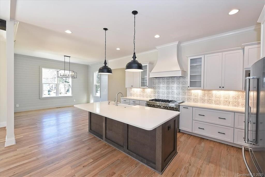 608 Marsh Road Charlotte, NC 28209 - Photo 10 of 31 a kitchen with a stove window and wooden floor