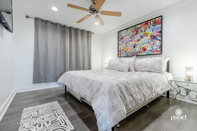 a large bed sitting in a bedroom and painting on the wall