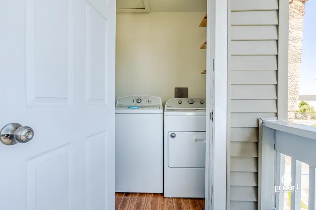an aerial view of a residential apartment building with a yard and parking space