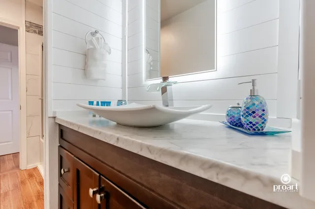 a bedroom with a bed and a painting on the wall