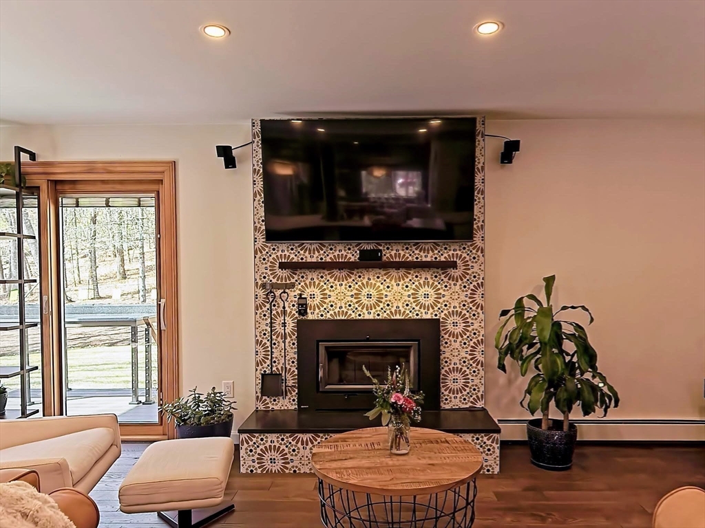 8 Fredrickson Road Norfolk, MA 02056 - Photo 19 of 39 a living room with furniture and a fireplace