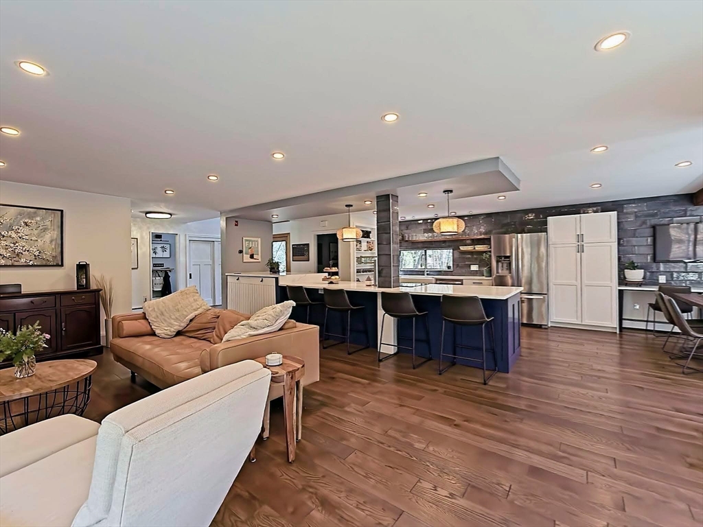 8 Fredrickson Road Norfolk, MA 02056 - Photo 22 of 39 a living room with furniture a dining table and kitchen view