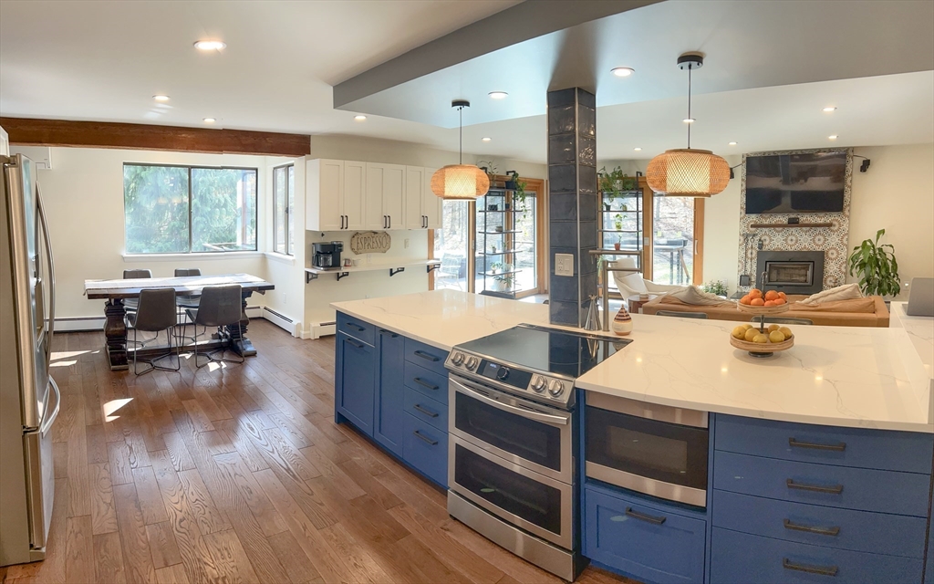 8 Fredrickson Road Norfolk, MA 02056 - Photo 26 of 39 a kitchen with stainless steel appliances granite countertop wooden floors wooden cabinets and sink