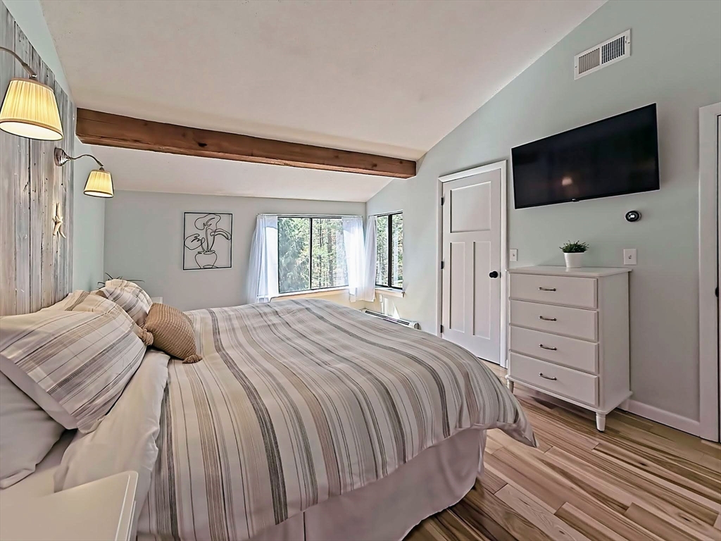 8 Fredrickson Road Norfolk, MA 02056 - Photo 29 of 39 a bedroom with a large bed and a flat screen tv