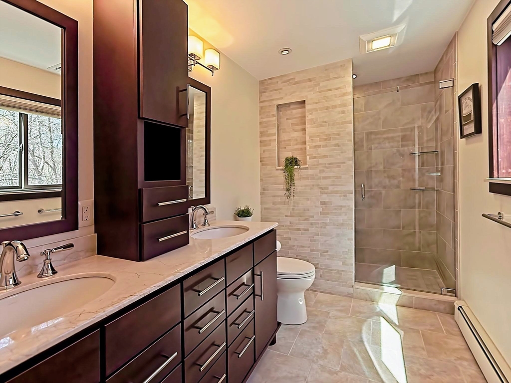 8 Fredrickson Road Norfolk, MA 02056 - Photo 30 of 39 a bathroom with a double vanity sink toilet and shower