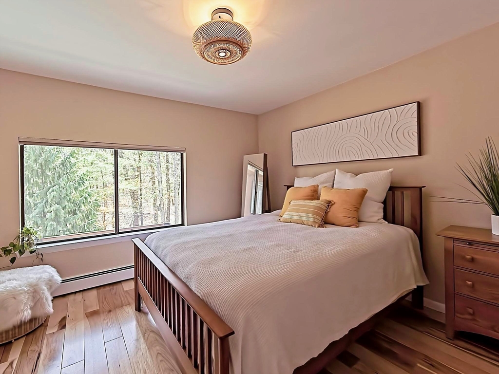 8 Fredrickson Road Norfolk, MA 02056 - Photo 32 of 39 a bedroom with a bed and wooden floor