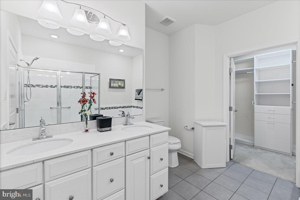 54 Heals Farm Road Burlington, NJ 08016 - Photo 16 of 26 a bathroom with a double vanity sink and a mirror